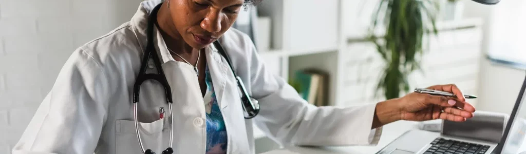 a black woman doctor checking medical files