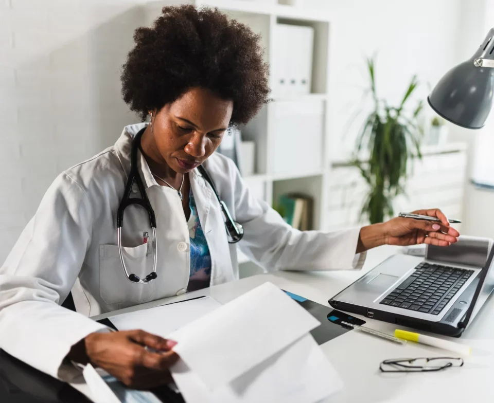 a black woman doctor checking medical files