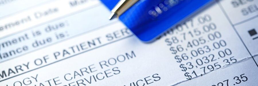 hospital bill and a credit card on top of it