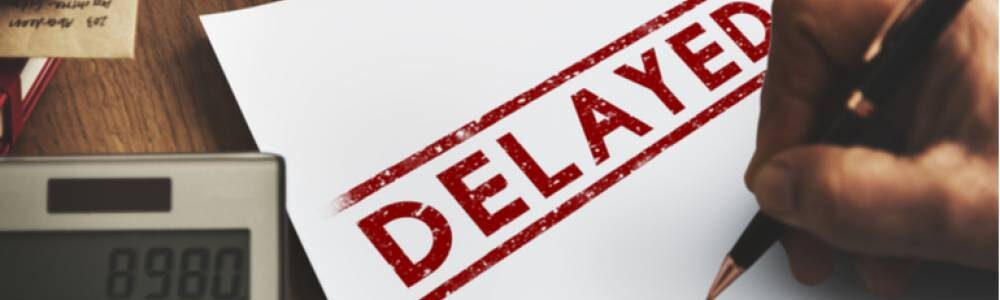 white paper with "DELAYED" in capitals with red marker