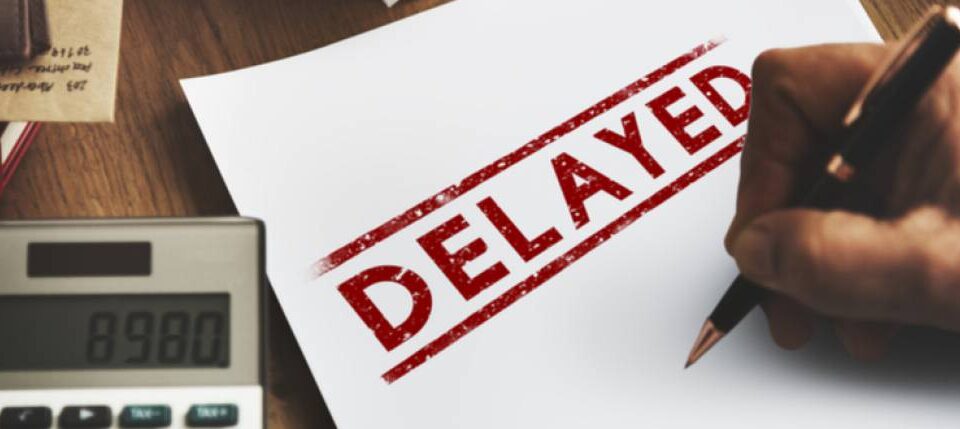 white paper with "DELAYED" in capitals with red marker