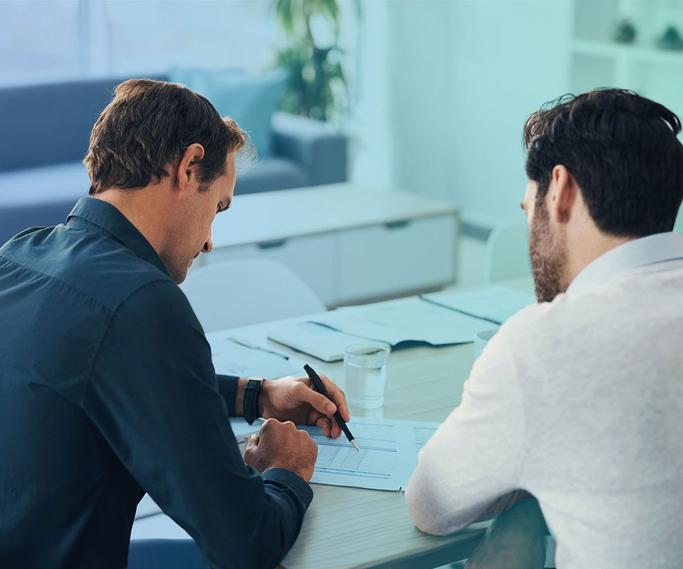 Business discussion between two male coworkers